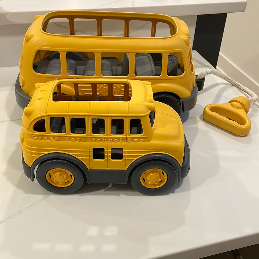 Pair of new green toy school buses